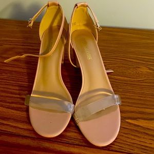 Nude heels with a clear strap.